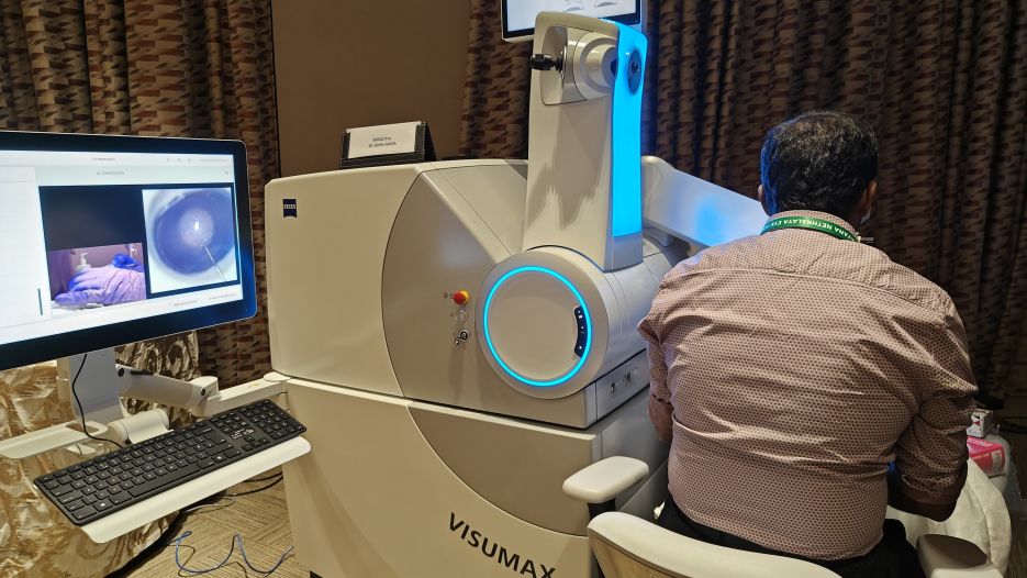 Smile Pro Wetlab being performed on VisuMax 800 from Zeiss Meditec AG. Note the LASER arm is currently raised up and the lowered microscope arm(obscured by the surgeon) is being used